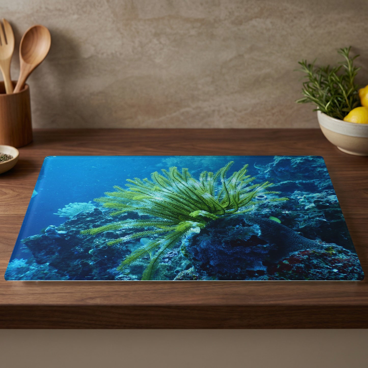Glass cutting board with image of vibrant green sea lily and coral reef.