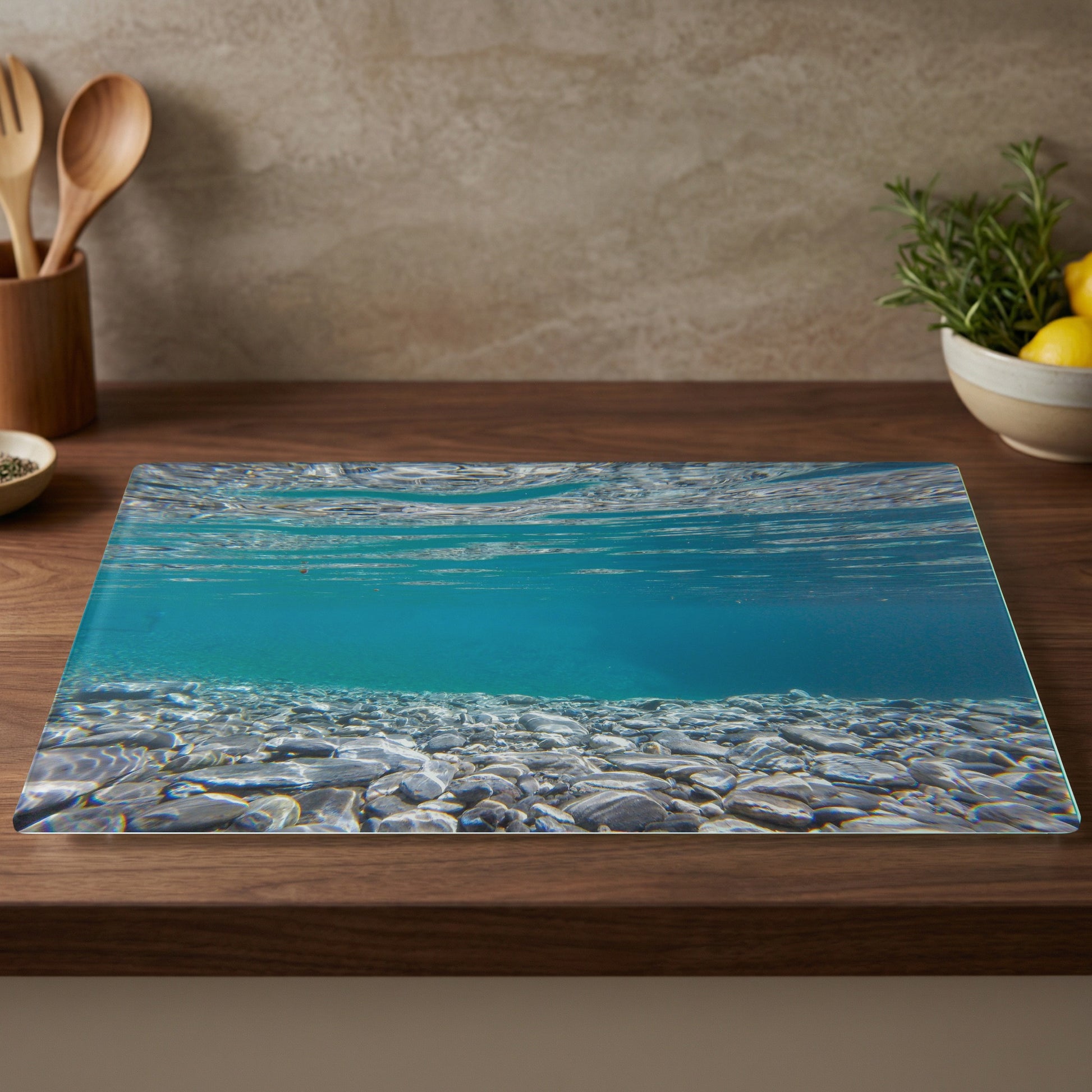 Underwater view of a clear lake with pebbles and a wooden countertop.